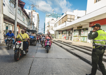A police officer and commuters in downtown San Andres Island, Colombia, March 2017